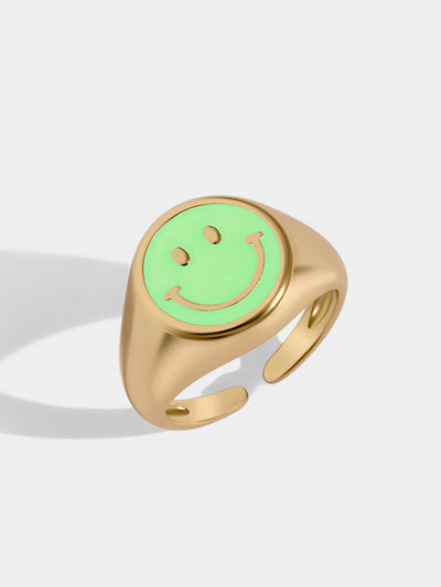 Gold paved ring with one big smiley face in the middle aqua green. Adjustable to fit you. 